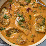 Tuscan Chicken in a creamy sauce with spinach and sun dried tomatoes.