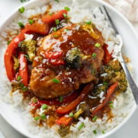 Honey Garlic Chicken with a thick glaze and vegetables on a bed of white rice.