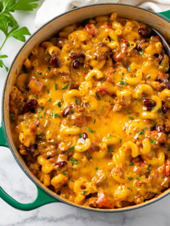 A Dutch oven filled with Cheesy Chili Mac.