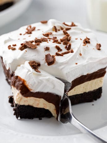 A fork cutting into a slice of Peanut Butter Delight.