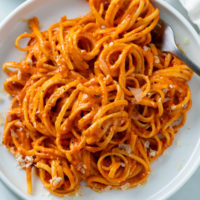 Roasted Red Pepper Pasta on a white plate with a fork.