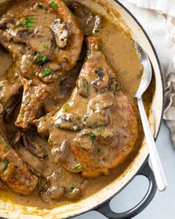 Mushroom Pork Chops in a skillet with gravy.