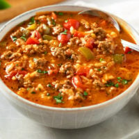 A bowl of Stuffed Pepper Soup with seasoned ground beef, peppers, tomatoes, and rice.