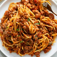 Spaghetti with Meat Sauce on a white plate with a fork.