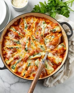 A round pot filled with cheesy stuffed shells.