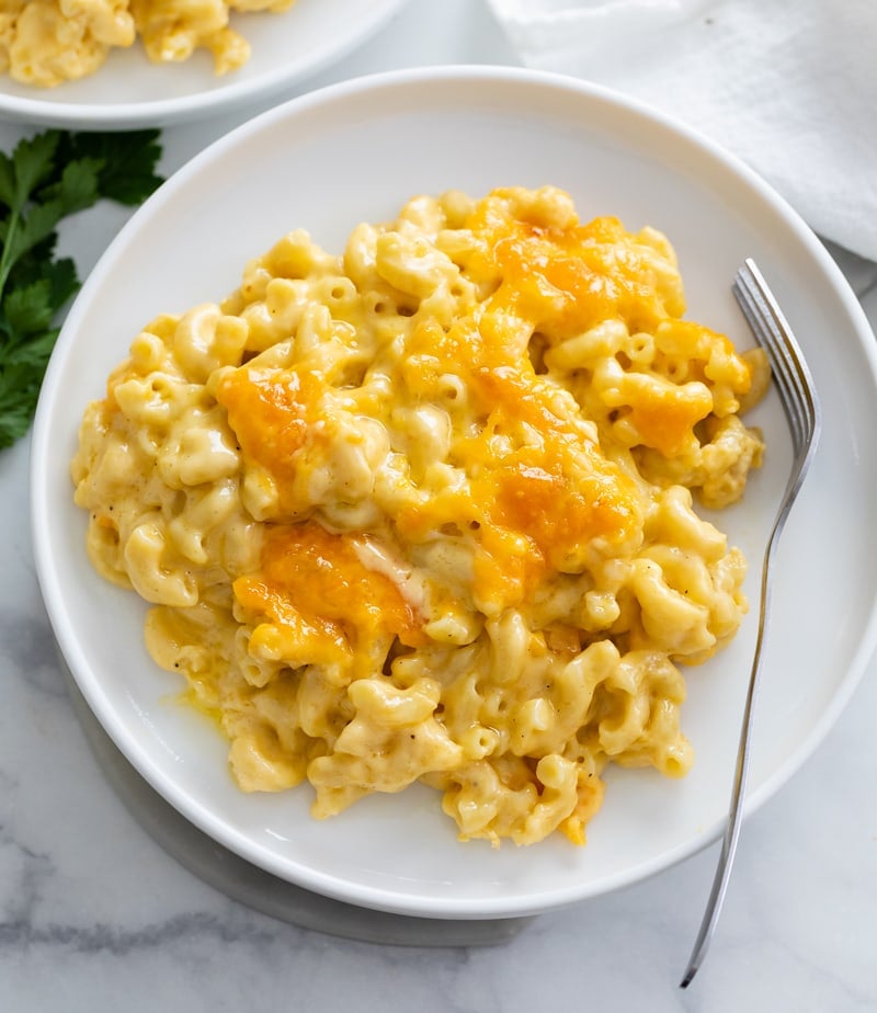 Baked Mac and Cheese on a white plate with a fork on the side.