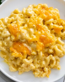 Baked Mac and Cheese on a white plate with a fork on the side.