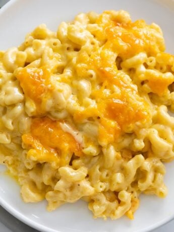 Baked Mac and Cheese on a white plate with a fork on the side.