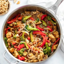 Chicken Noodle Stir Fry in a skillet with broccoli, bell peppers, chicken, and noodles.