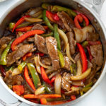 Pepper Steak with onions and peppers in a skillet with sauce.