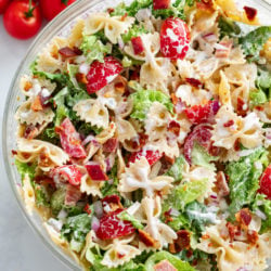 A glass bowl filled with BLT Pasta Salad with creamy Ranch dressing.