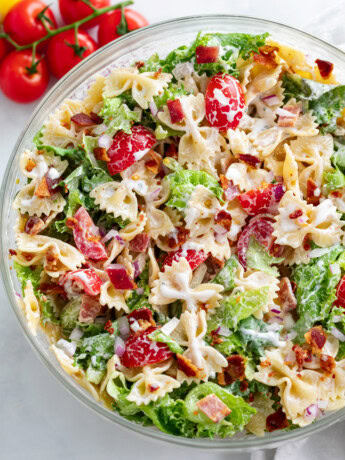 A glass bowl filled with BLT Pasta Salad with creamy Ranch dressing.