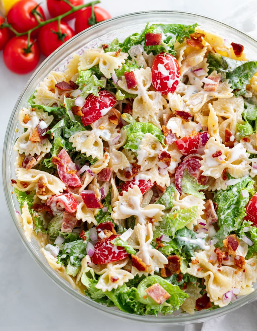 A glass bowl filled with BLT Pasta Salad with creamy Ranch dressing.