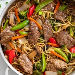 Beef Stir Fry with Noodles in a skillet with sauce and vegetables.