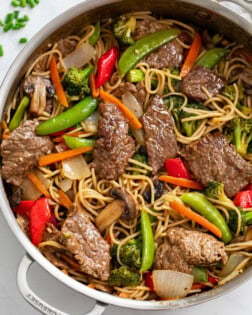 Beef Stir Fry with Noodles in a skillet with sauce and vegetables.