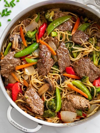 Beef Stir Fry with Noodles in a skillet with sauce and vegetables.