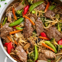 Beef Stir Fry with Noodles in brown sauce in a skillet with vegetables.