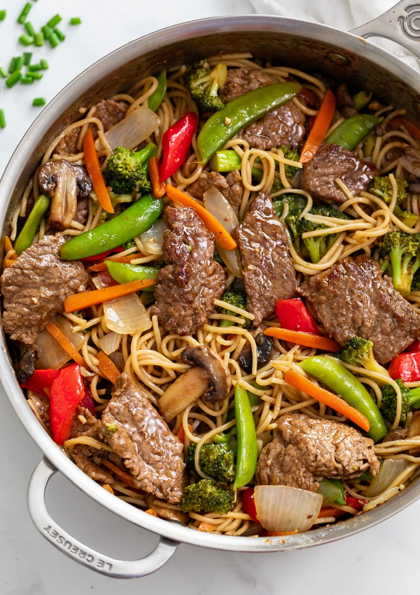 Beef Stir Fry with Noodles in a skillet with sauce and vegetables.