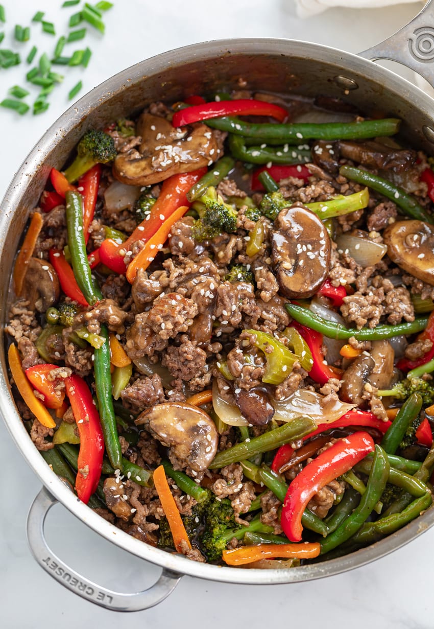 A skillet filled with Ground Beef Stir Fry with sesame seeds on top.