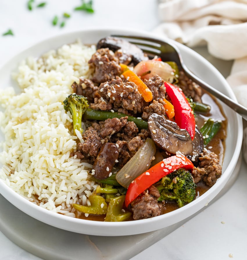 Ground Beef Stir Fry with white rice on a white plate.