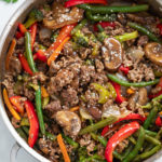 Ground Beef Stir Fry in a skillet with a brown sauce and vegetables.