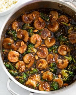 Honey Garlic Chicken in a skillet with a brown sauce and broccoli.