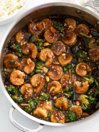 Honey Garlic Chicken in a skillet with a brown sauce and broccoli.