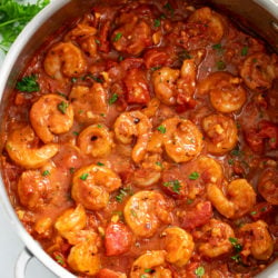 A skillet filled with Shrimp Fra Diavolo with fresh parsley.