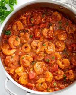 A skillet filled with Shrimp Fra Diavolo with fresh parsley.