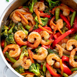 A skillet filled with Shrimp Stir Fry in a brown sauce with vegetables.