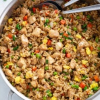 Chicken Fried Rice in a skillet with vegetables, brown sauce, and eggs.