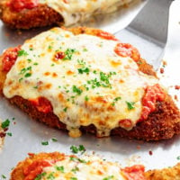 Chicken Parmesan with marinara sauce and melted mozzarella cheese on top.