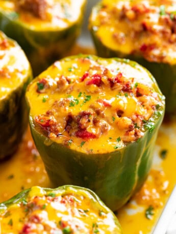 Stuffed Bell Peppers in a Casserole dish with meat and cheese.