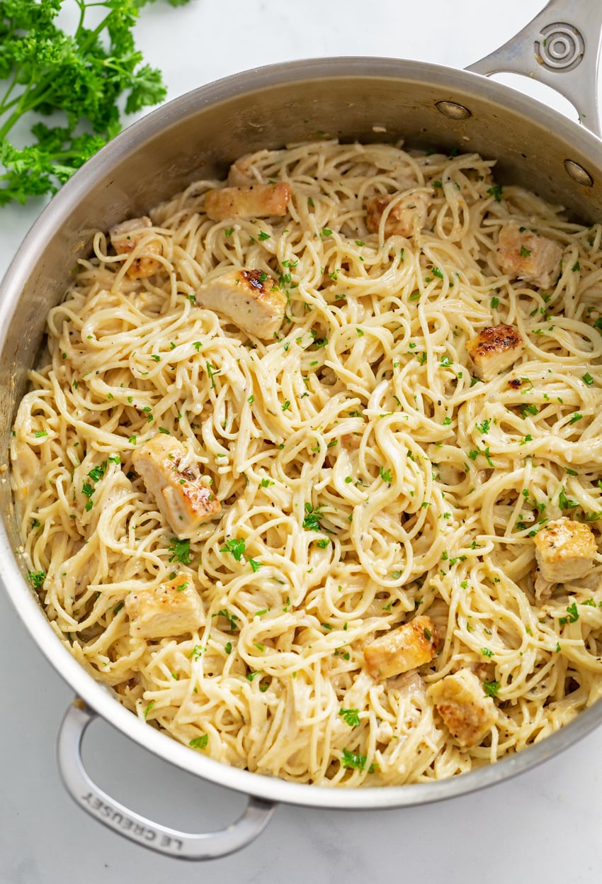 Angel Hair Pasta with Chicken in a large skillet with parsley on top.