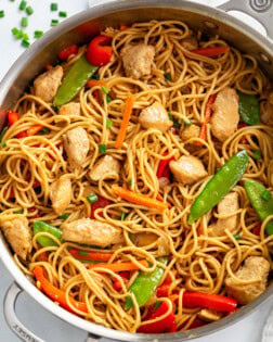 Chicken Lo Mein in a skillet with vegetables and sauce.