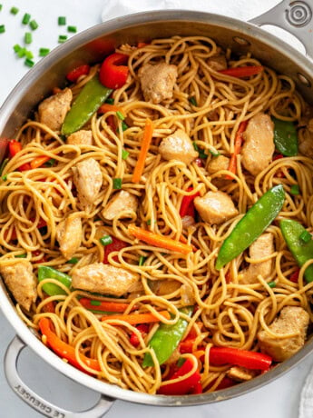 Chicken Lo Mein in a skillet with vegetables and sauce.