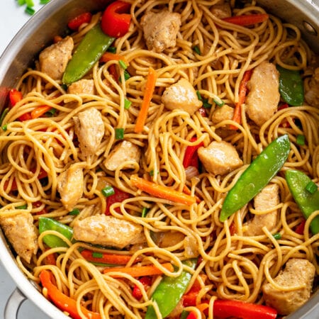 Chicken Lo Mein in a skillet with vegetables and sauce.