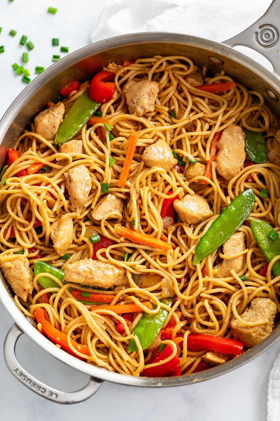Chicken Lo Mein in a skillet with vegetables and sauce.