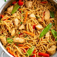 Chicken Lo Mein with vegetables and sauce in a skillet.