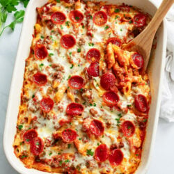 Pizza Pasta in a white casserole dish with pepperoni on top.