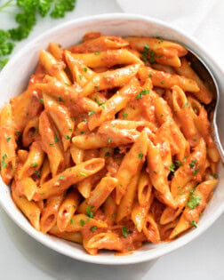 A bowl of Penne Alla Vodka with parsley on top.