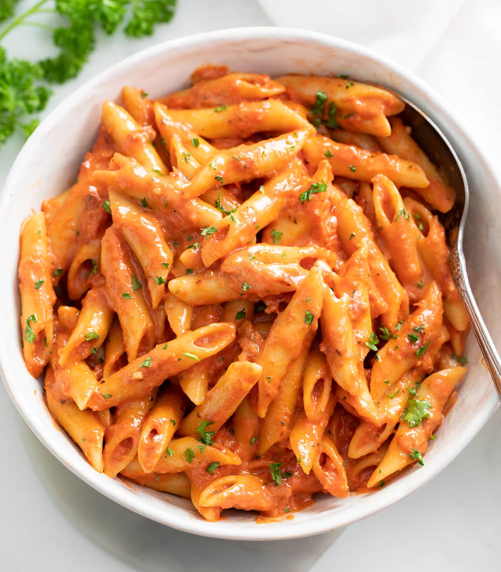 A bowl of Penne Alla Vodka with parsley on top.