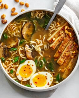 A bowl of Homemade Ramen with topped with soft boiled eggs and green onions.