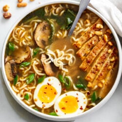 Homemade Ramen in a soup bowl with chicken, mushrooms, Bok Choy, and soft boiled eggs.