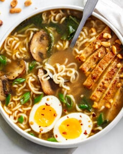 Homemade Ramen in a soup bowl with chicken, mushrooms, Bok Choy, and soft boiled eggs.