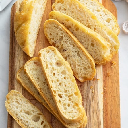 Slices of No Knead Bread on a cutting board.