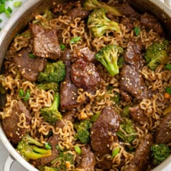 A skillet of Ramen Noodles with Beef and Broccoli in a brown sauce.