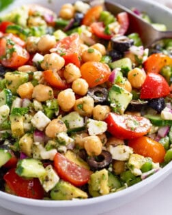 Chickpea Salad with feta cheese, dressing, and vegetables.