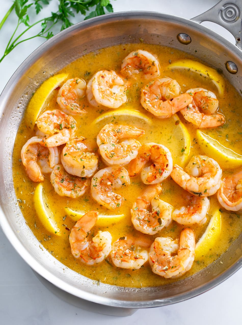 Garlic Butter Shrimp in a skillet with a buttery garlic sauce and lemon wedges.