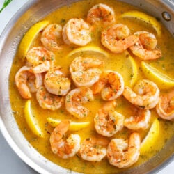 Garlic Butter Shrimp in a buttery garlic sauce with lemon wedges in a skillet.